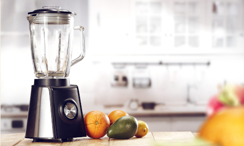 A blender and fruits in a kitchen