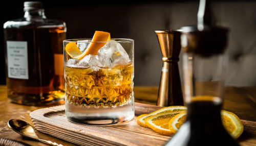 Glass of whisky with an orange zest