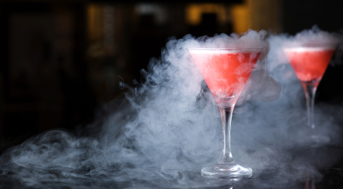 Two cocktails releasing smoke