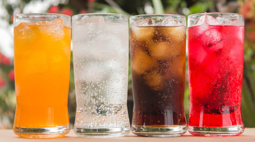 4 glasses of sodas with different flavors