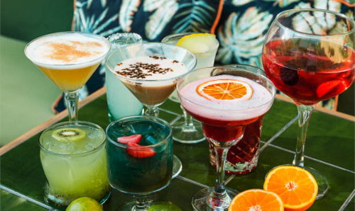 Different colorful cocktails with fruit pieces