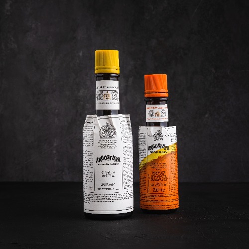Una botella de Angostura Aromatic Bitters y Angostura Orange Bitters sobre fondo negro.